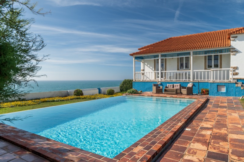 Garden in bloom beside the infinity pool and the sea