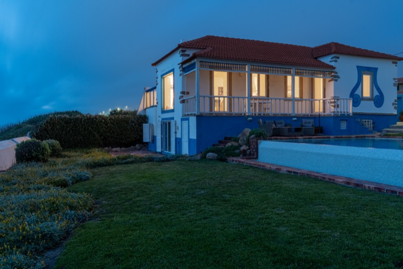 Villa and lawn under a deep blue evening sky