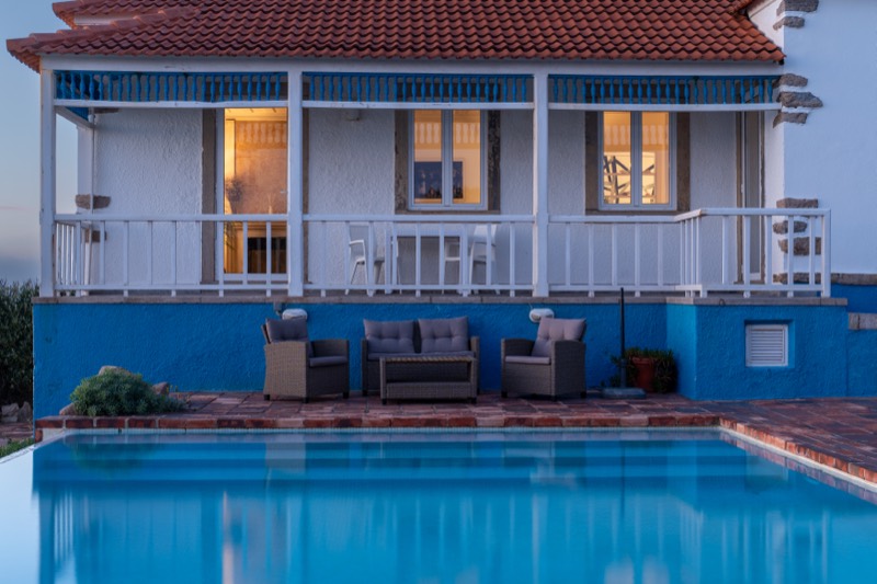 Veranda glowing at blue hour above the pool