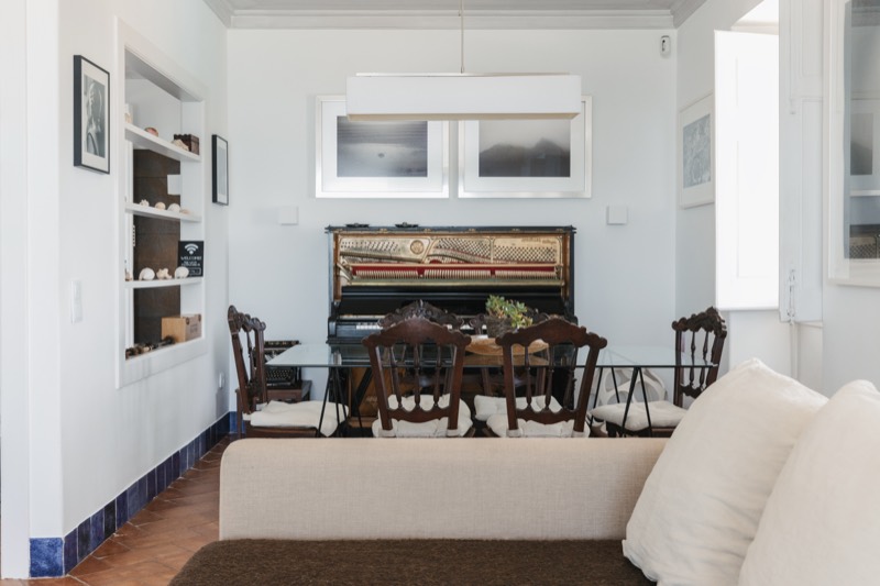 Second living room, dining table set before the 1907 piano