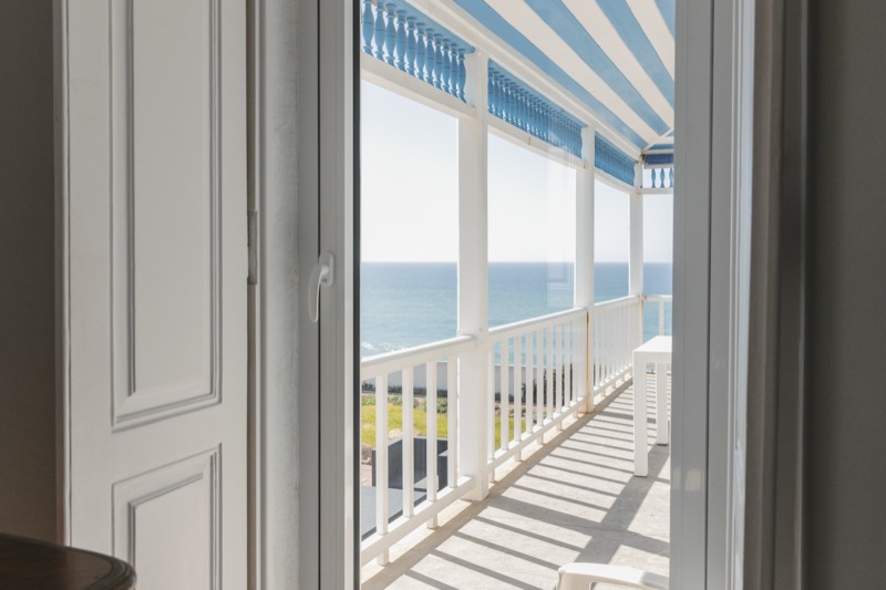 Striped veranda awning over the ocean