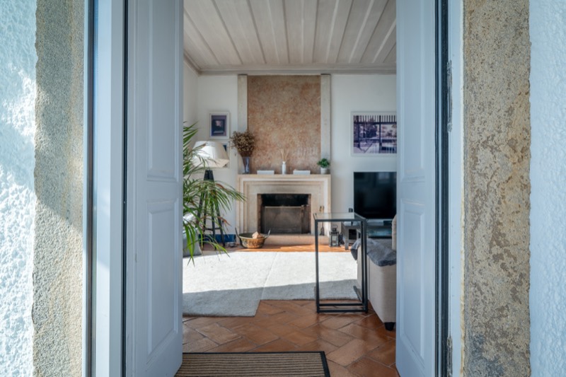 View through stone doorway into the fireplace room